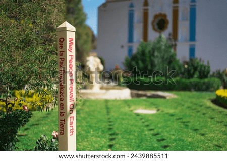 May Peace Prevail on Earth - sign on beautiful church in the park of El Tule, Santa Maria Del Tule, Oaxaca, Mexico