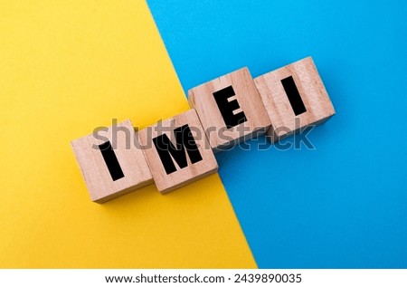 A wooden cube with word  “IMEI” on it. IMEI stands for “International Mobile Equipment Identity”