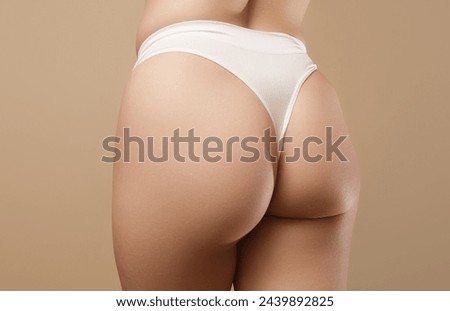 people, health and lifestyle concept - Beautiful Woman Body In Shape. Closeup Healthy Girl With Fit Slim Body, Soft Skin And Firm Buttocks, Hips In White Bikini Panties. Tight Big Butt In Underwear.