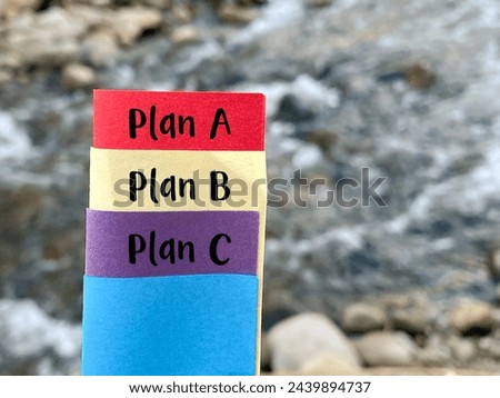 Inspirational Success Concept - Plan A plan B plan C on multiple color papers with nature background. Stock photo.