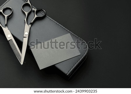 Hairdressing scissors and businesscard mock up on black background
