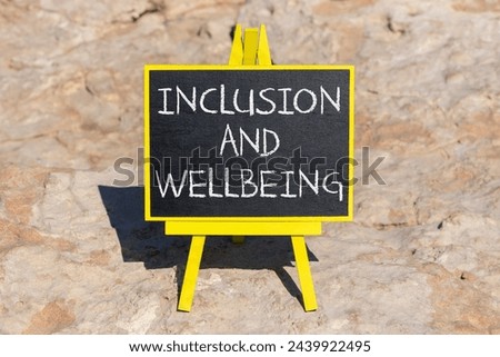 Inclusion and wellbeing symbol. Concept words Inclusion and wellbeing on beautiful black chalk blackboard. Beautiful stone background. Motivational inclusion and wellbeing concept. Copy space.