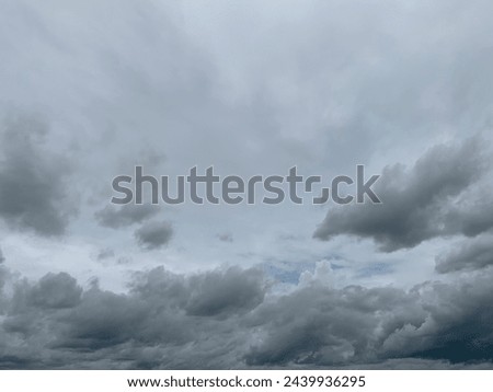 Gray nimbostratus clouds roll in layers above the sky, carried by the wind Long continuous rain in Trang Province, Thailand. No focus Royalty-Free Stock Photo #2439936295