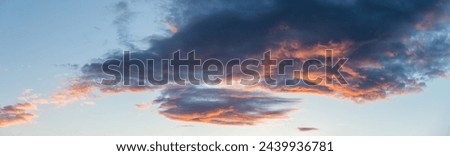 Captivating clouds at sunset, painted with vibrant hues, perfect for evocative and atmospheric visuals Royalty-Free Stock Photo #2439936781