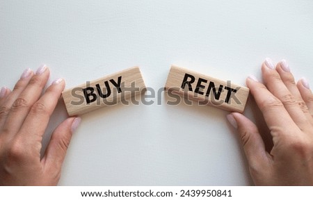 Buy or Rent symbol. Concept word Buy or Rent on wooden blocks. Businessman hand. Beautiful white background. Business and Buy or Rent concept. Copy space