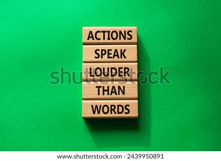 Actions speak louder than Words symbol. Wooden blocks with words Actions speak louder than Words. Beautiful green background. Business and Actions concept. Copy space.