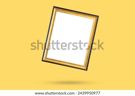 Blank golden vintage wood picture photo frame isolated on yellow background