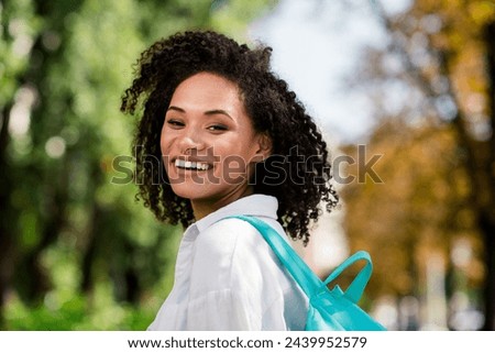 Photo of dreamy adorable woman dressed white shirt backpack enjoying journey warm weather outdoors urban city park