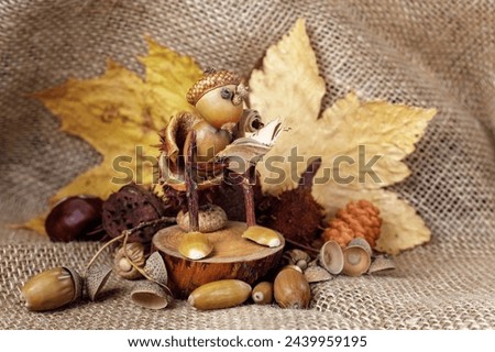 Autumn crafts. Children's fall crafts and creativity, Gnome made from acorn and chestnut on dry stump. Ideas for children's art, hometime hobby. Horizontal photo.