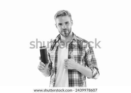 man with haircare cosmetics on background, thumb up. man with haircare cosmetics in studio.