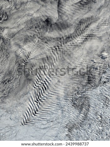 Shipwaveshaped wave clouds induced by South Sandwich Islands. Shipwaveshaped wave clouds induced by South Sandwich Islands. Elements of this image furnished by NASA. Royalty-Free Stock Photo #2439988737