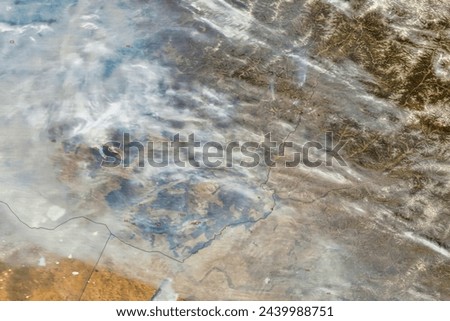 Wildfires in Southern Siberia. During spring 2015, several fires lit by farmers escaped control and raced through villages in southern Siberia. Elements of this image furnished by NASA. Royalty-Free Stock Photo #2439988751