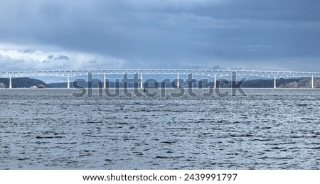 view of the Kingston-Rhinecliff Bridge from Kingston point beach (continuous under deck truss toll bridge across hudson river in new york state) Royalty-Free Stock Photo #2439991797