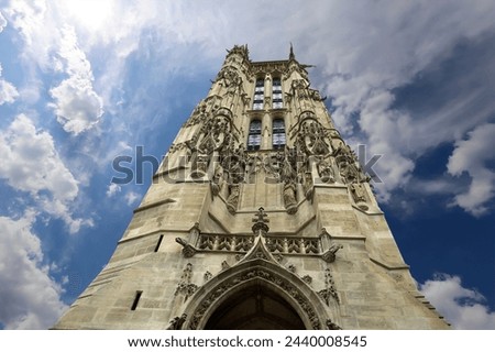 Saint-Jacques Tower (Tour Saint-Jacques) against the background of a beautiful sky with clouds. Located on Rivoli street, Paris, France. This 52 m Flamboyant Gothic tower (XVI century)    
