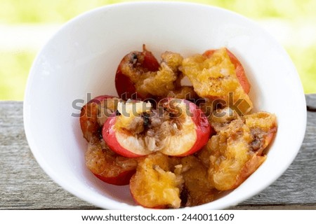 Wormy apricots on plates. Rotten apricots Royalty-Free Stock Photo #2440011609