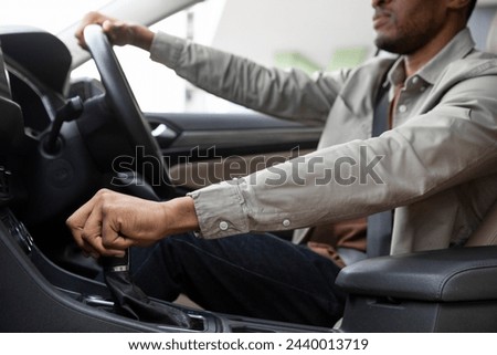 African american man driving his car shifting gears Royalty-Free Stock Photo #2440013719