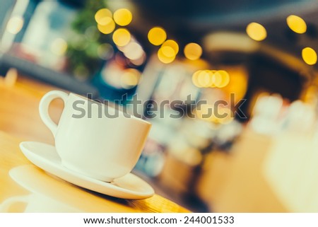 Black coffee in white cup on wooden table in coffee shop cafe - Vintage effect style pictures