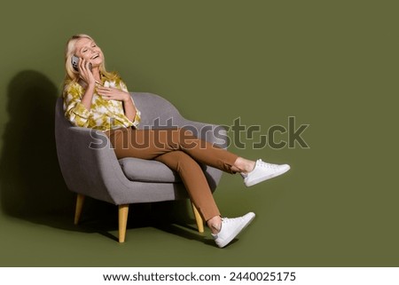 Full body length photo of funny laughing blonde hair businesswoman touch chest phone call to family isolated on khaki color background