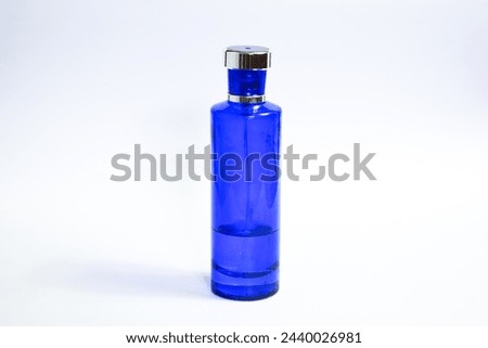 Transparent Dark Blue Bottle Perfume isolated black background for mock up design