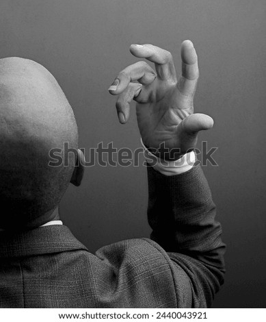 man praying to god with hands together Caribbean man praying with grey black background stock photo