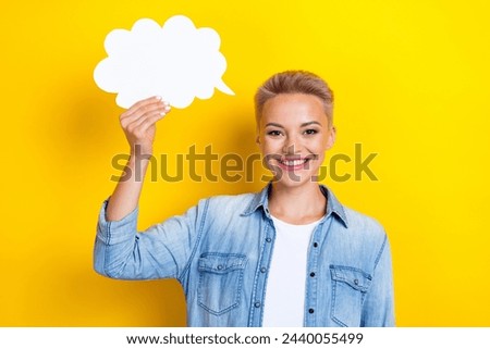 Photo portrait of lovely young lady hold comics speech cloud wear trendy jeans garment isolated on yellow color background
