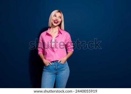 Photo of overjoyed woman with bob hairstyle dressed pink shirt look at impressive sale empy space isolated on dark blue background