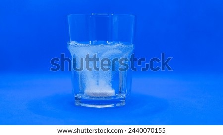 Glass of water to dissolve an effervescent tablet