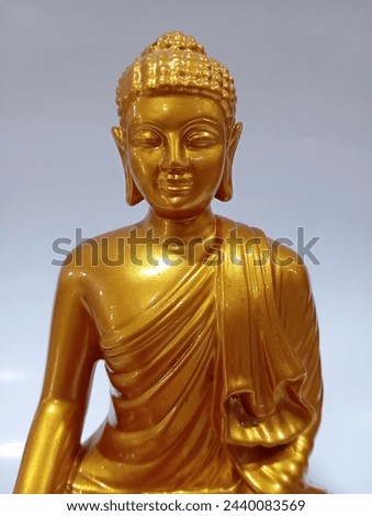 Indonesia, March 21,2024 : photo of a gold Buddha statue . Buddha is Sitting Meditation on White Background.  Royalty-Free Stock Photo #2440083569