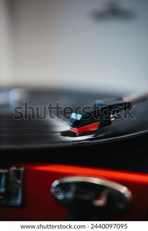 Macro shot of a turntable needle on a spinning vinyl record, capturing the essence of analog music