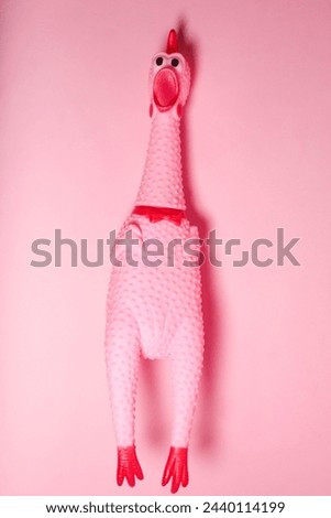 screaming chicken toy on pink background