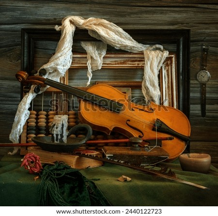 Old forgotten things. A violin with a broken string, an extinguished candle, old picture frames, a wooden abacus.