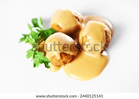 A picture of traditional swedish meatballs served with cream sauce