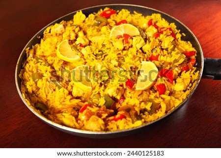 A picture of a fresh home made paella served on a frying pan