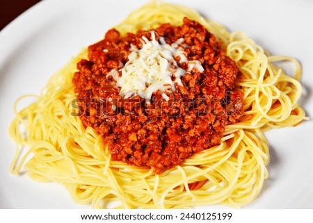 A picture of fresh spaghetti served on a white plate