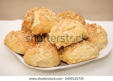 A picture of a pile of home-made sweet buns over light background