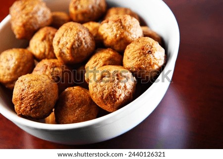 A picture of a bowl full of traditional Swedish meatballs