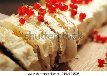 A picture of Polish traditional cake with redcurrant presented on a wooden board