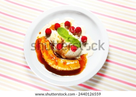 A picture of banana split dessert served on a white plate
