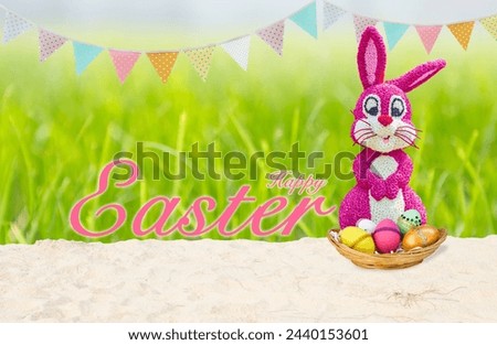 Happy easter with pink flower rabbit and easter egg in wooden tray over blurred green grass background, greeting card background idea