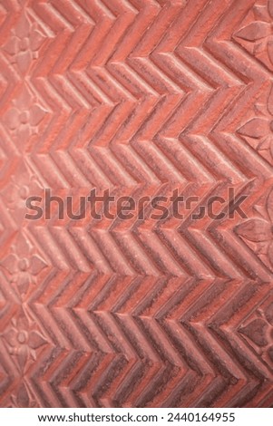 Chevron pattern carving in red sandstone. Intricate carvings at Fatehpur Sikri. Mughal Indian architecture. Popular zigzag chevron grunge pattern background. wall texture background. sstkbackgrounds