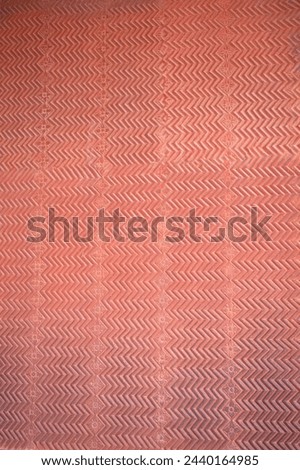 Chevron pattern carving in red sandstone. Intricate carvings at Fatehpur Sikri. Historic Mughal Indian architecture at Fatehpur Sikri Agra. Popular zigzag chevron grunge pattern red brown background