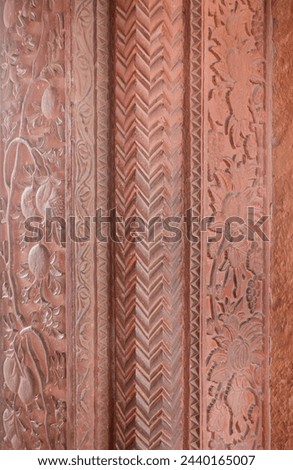 Chevron pattern carving in red sandstone. Intricate carvings at Fatehpur Sikri, India. Historic Mughal Indian architecture at Fatehpur Sikri Agra. Popular zigzag chevron grunge pattern background