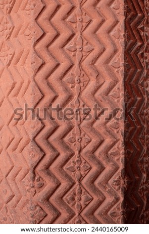Chevron pattern carving in red sandstone. Intricate carvings at Fatehpur Sikri. Mughal Indian architecture at Fatehpur Sikri Agra. Popular zigzag chevron grunge pattern background. sstkbackgrounds