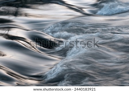 Rapid water flows in stream over stony bottom making cascades - abstract landscape close up Royalty-Free Stock Photo #2440183921