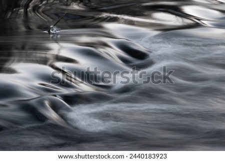 Rapid water flows in stream over stony bottom making cascades - abstract landscape close up Royalty-Free Stock Photo #2440183923