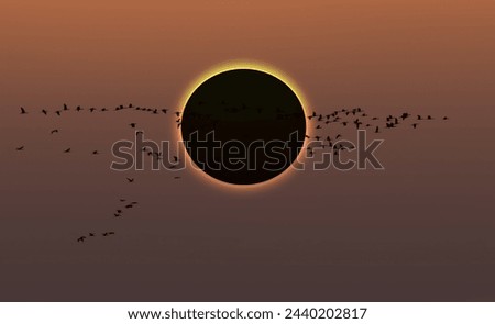 Migratory birds flying in the sky with Solar Eclipse at amazing sunset Royalty-Free Stock Photo #2440202817