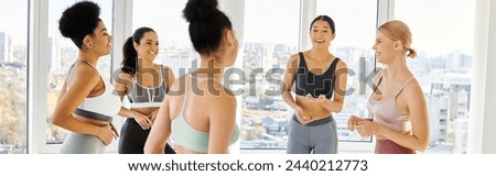 group of five happy multicultural women in sportwear and chatting before pilates class, banner Royalty-Free Stock Photo #2440212773