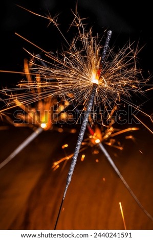 Bengal fire. Burning Holiday sparkler candle. Black background Royalty-Free Stock Photo #2440241591