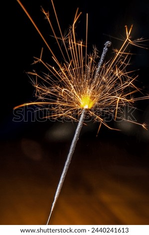Burning Bengal fire. Sparkler candle. Holiday Royalty-Free Stock Photo #2440241613