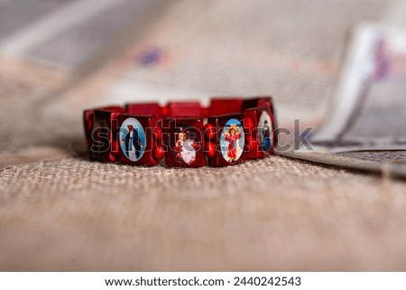 Christianity red wooden wrist decoration bracelet, with small pictures of Jesus saint maria and so on.